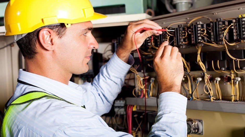 Electrician working on electrical panel in Denver